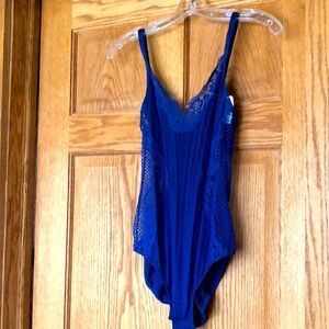 New / tag. blue body suit. Soft material with spandex lace accent. Snap crotch.